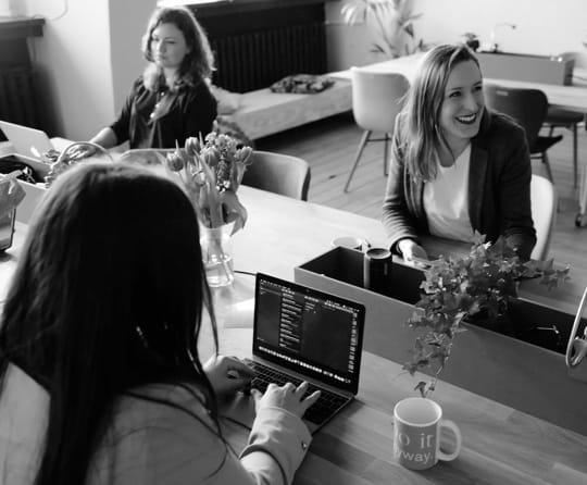 Three women working at a desk