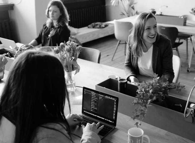 Three women working at a desk